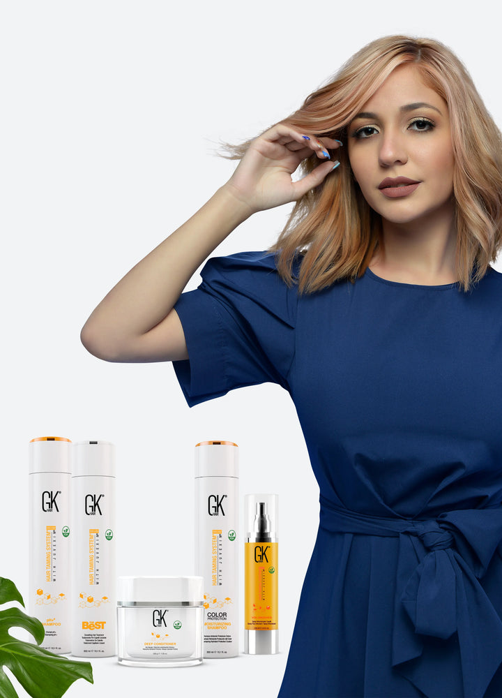Blonde model in a navy dress above GK Hair pH+ Shampoo, The Best, Deep Conditioner, Color Protection Moisturizing Shampoo and VolumizeHer