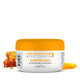 GK Hair Shaping Wax 100 g white jar with an orange lid, honeycomb and dripping honey beside it on white