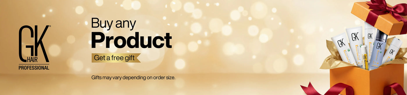 Orange gift box with a red bow open to reveal GK Hair products inside. Text reads "Buy any Product, Get a free gift" on a soft golden background.