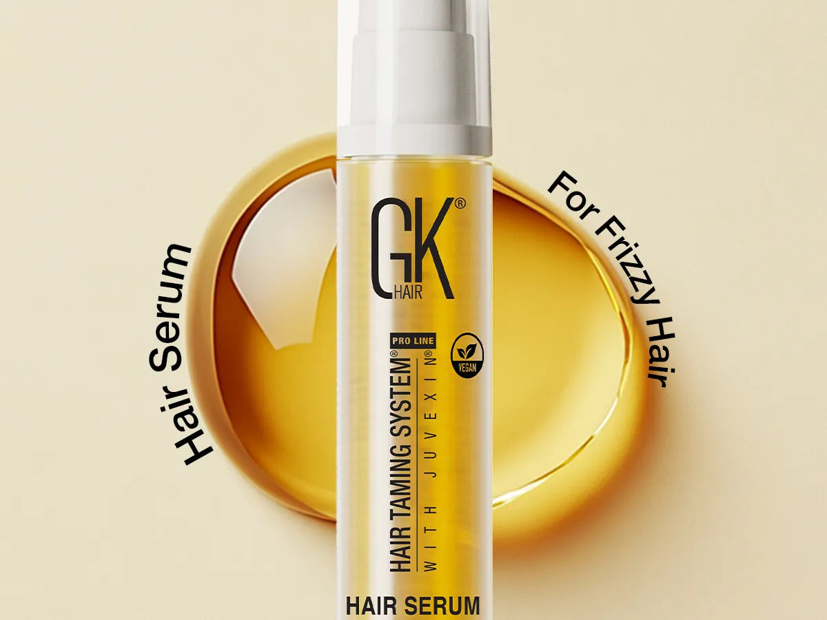 Transparent GK Hair Argan Oil Serum on a light background with a liquid splash. Text: "Hair Serum," "For Frizzy Hair," conveys smoothness.