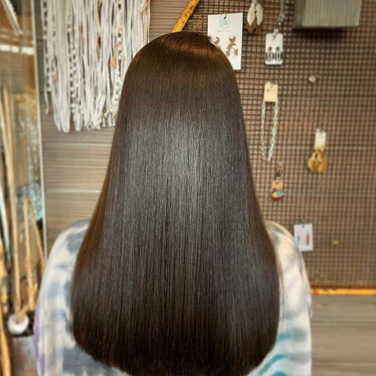 After: long sleek glossy dark brown hair from behind in the same salon, smooth rounded ends