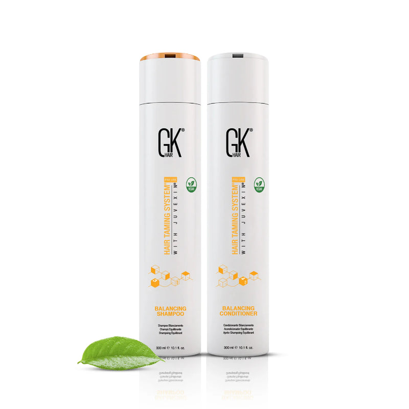 GK Hair Balancing Shampoo and Balancing Conditioner, 300 ml each, standing side by side with a green leaf on white