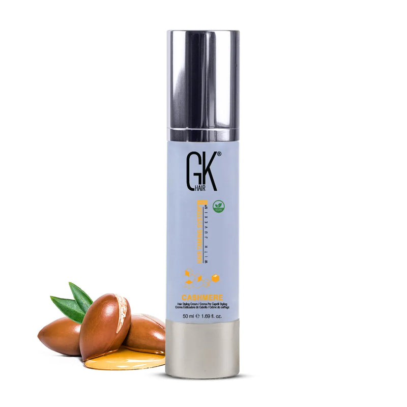 GK Hair Cashmere hair styling cream 50 ml, pale blue bottle with a chrome pump, argan kernels and oil at its base on white