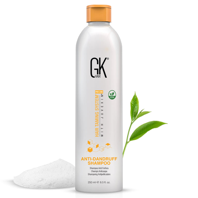 GK Hair Anti-Dandruff Shampoo 250 ml bottle with a green tea sprig and a mound of white lather on white
