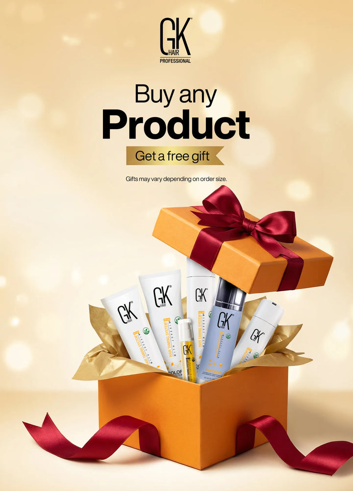 Orange gift box with a red bow open to reveal GK Hair products inside. Text reads "Buy any Product, Get a free gift" on a soft golden background.