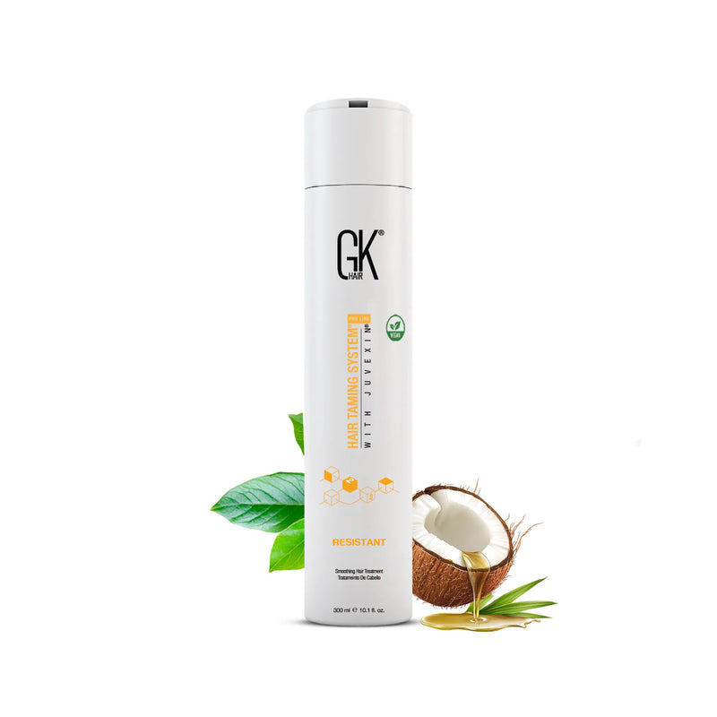 GK Hair Resistant Smoothing Hair Treatment 300 ml white bottle, front view beside a coconut dripping oil and green leaves