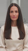 Product film: presenter introduces the purple GK Hair Cashmere styling cream and smooths it through long dark hair