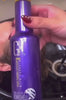 Salon reel: purple toner massaged through blonde hair at the basin, GK Hair Serum applied, then blow-dried to a sleek silver-blonde bob
